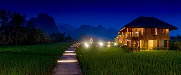 Exotica Resort & Spa, Andamans, a luxurious villa with a private pool and a view of palm trees, and lush green forests.